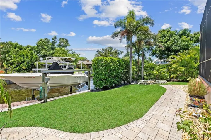 View of yard with a boat dock and 10,000 lb Boat Lift