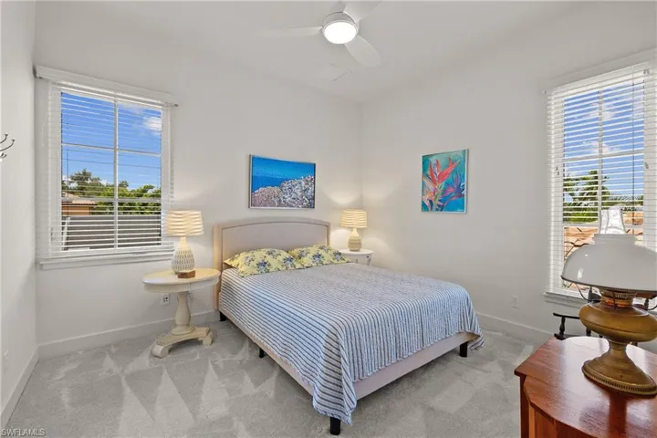 Bedroom featuring new carpet flooring and ceiling fan