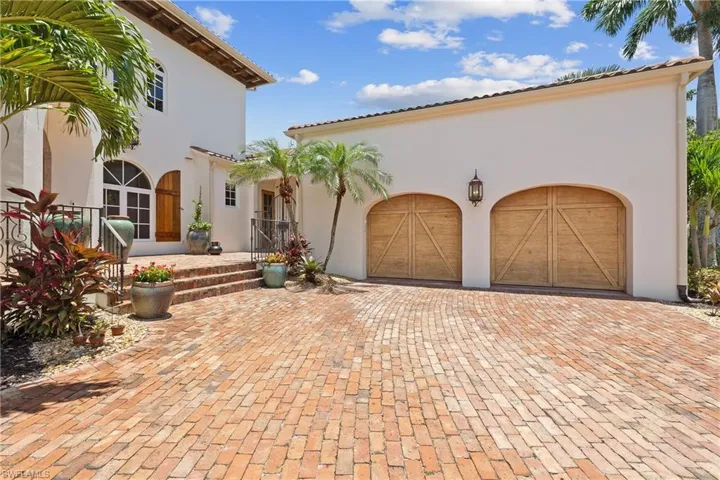 Mediterranean / Spanish-style house featuring garage