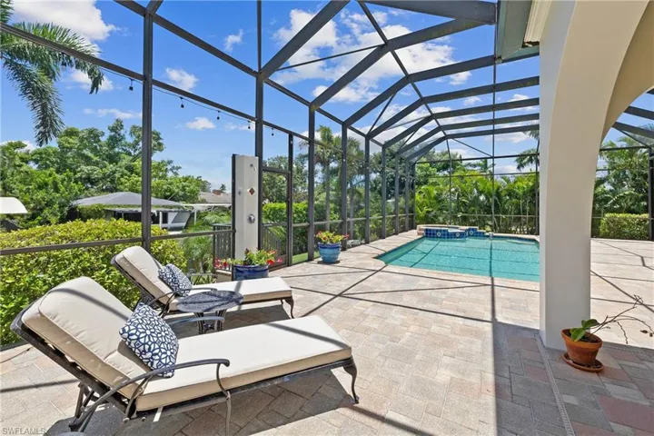 View of pool featuring a patio and screen enclosure