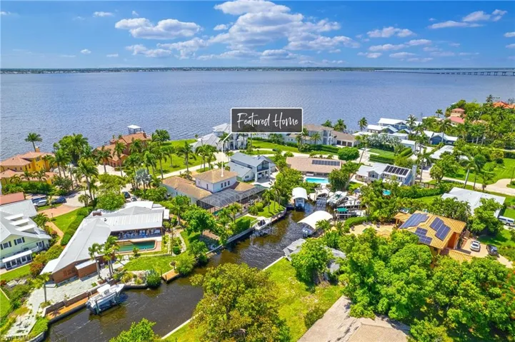 Birds eye view of property with a water view