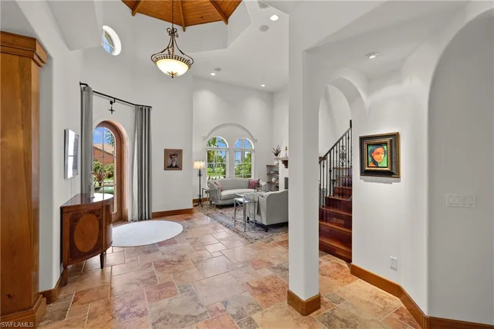 Tiled entryway with a towering ceiling
