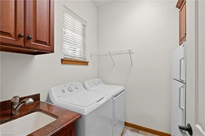Laundry Room featuring sink, tile flooring, cabinets, and 2023 washing machine and 2023 clothes dryer