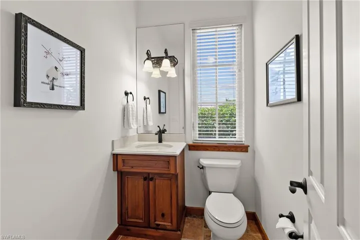Pool Bathroom with tile flooring and vanity with extensive cabinet space