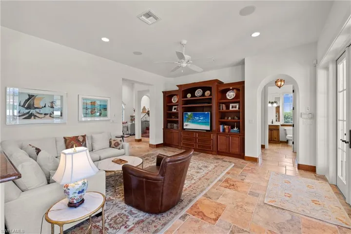 Tiled living room featuring Minka ceiling fan