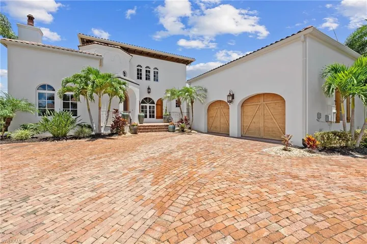 Mediterranean / spanish-style home with a garage