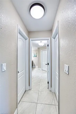 Hallway featuring a textured wall