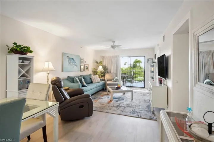 Living room with light wood finished floors and a ceiling fan