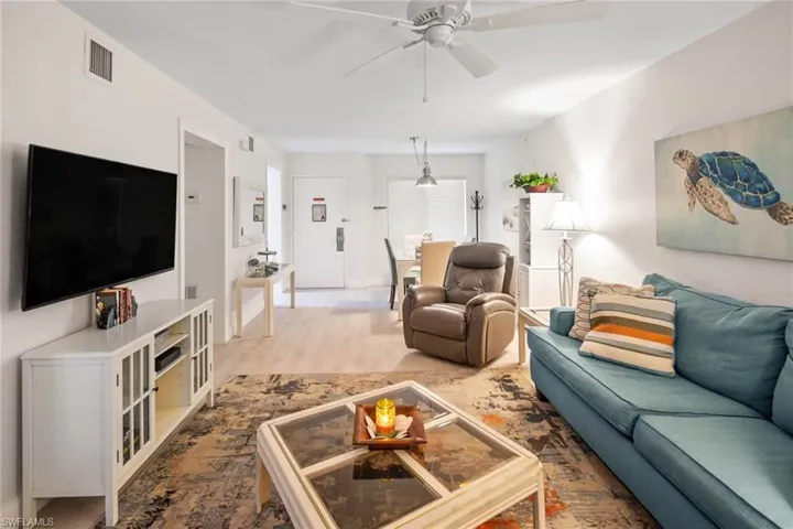 Living room featuring ceiling fan and light wood-style flooring