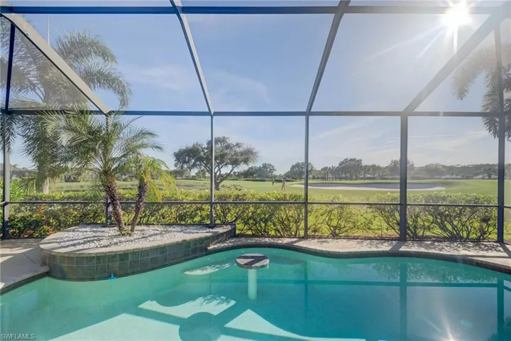 View of swimming pool with glass enclosure