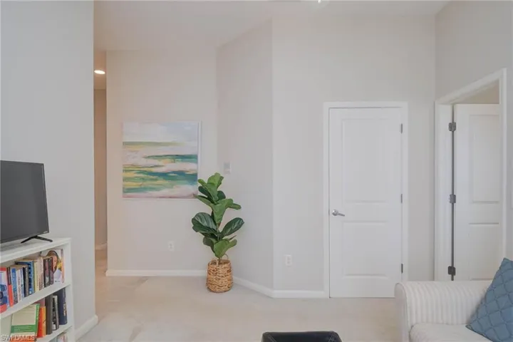 Sitting room featuring light carpet