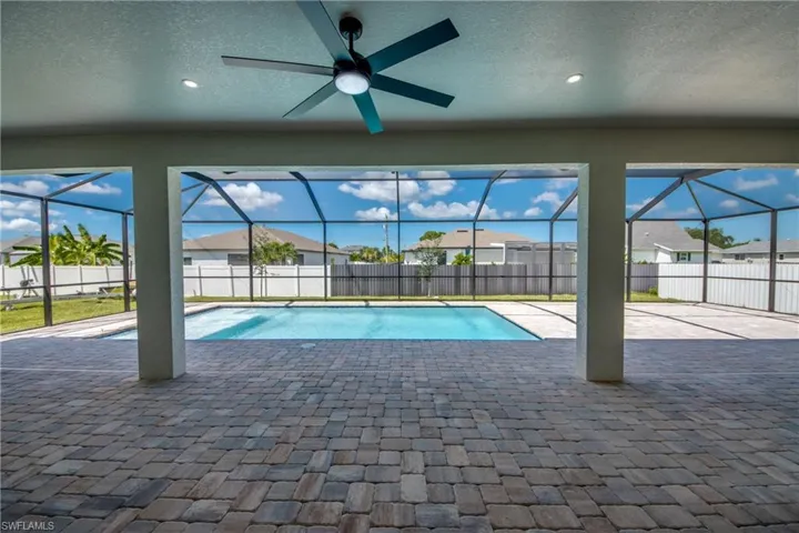 View of pool featuring a sunroom, a patio, and a fenced backyard