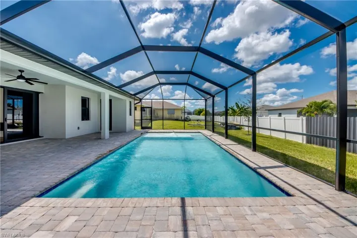 View of pool featuring ceiling fan, a patio area, a sunroom, and a lanai