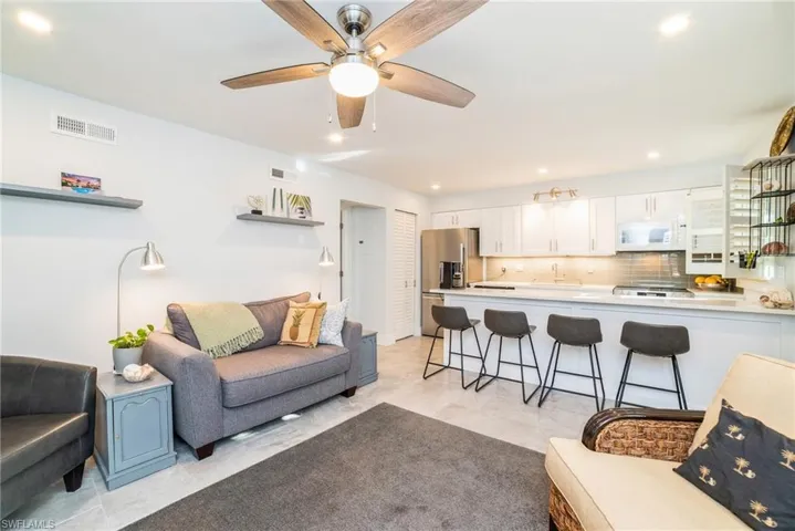 Living room with recessed lighting and ceiling fan