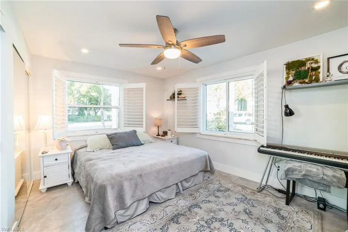 Bedroom with multiple windows, recessed lighting, and ceiling fan