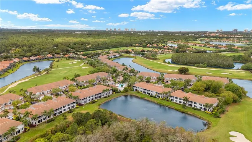 Aerial view with a water view and golf course view