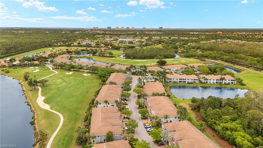 Drone / aerial view with golf course view and a water view