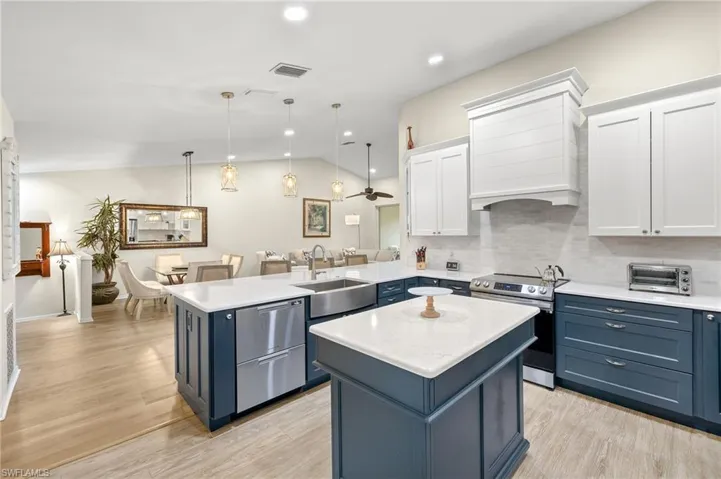 Check out the stainless farmhouse sink and double drawer dishwasher.