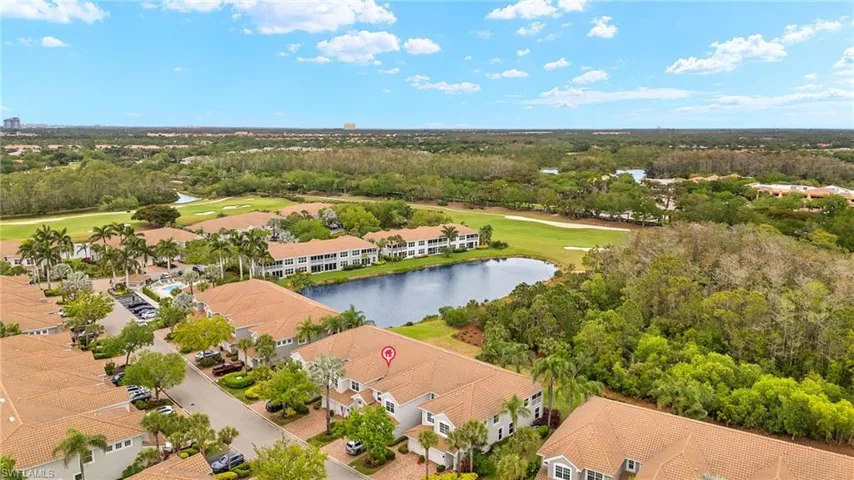 Aerial view with golf course view, a water view, and a residential view
