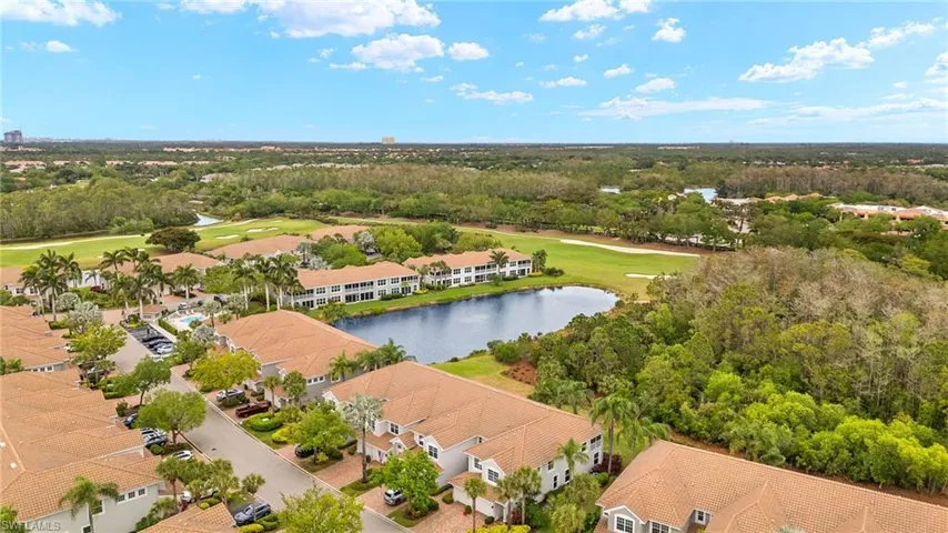 Aerial view with a residential view, golf course view, and a water view