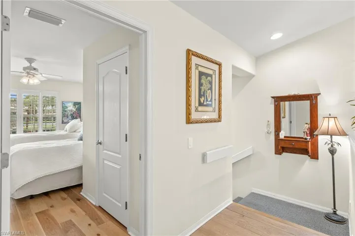 Corridor with recessed lighting, entry landing, guest room.