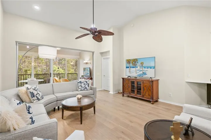 Vaulted ceiling, recessed lighting, light wood floors.