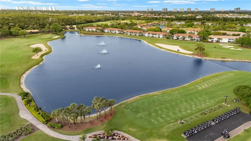 Birds eye view of property featuring view of golf course and a water view