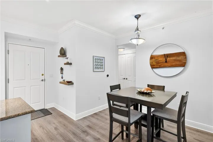 Dining space featuring light wood-style flooring and ornamental molding