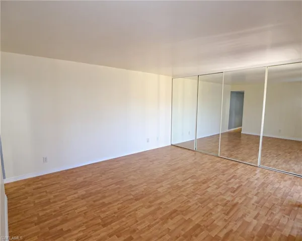 Unfurnished bedroom featuring light wood-style flooring and a closet