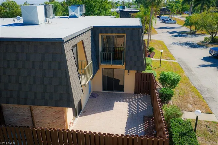 View of home's exterior with a balcony and brick siding