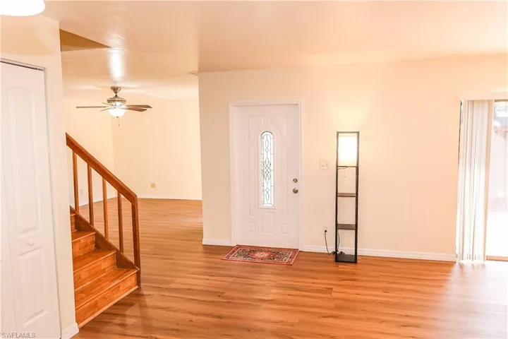 Entrance foyer featuring light wood finished floors and a ceiling fan