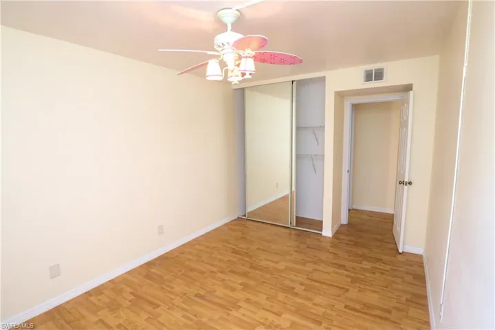 Unfurnished bedroom with light wood-type flooring, a closet, and ceiling fan