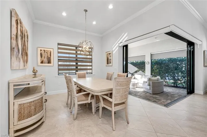 Dining area featuring crown molding, plenty of natural light, a chandelier, recessed lighting, and light tile patterned floors