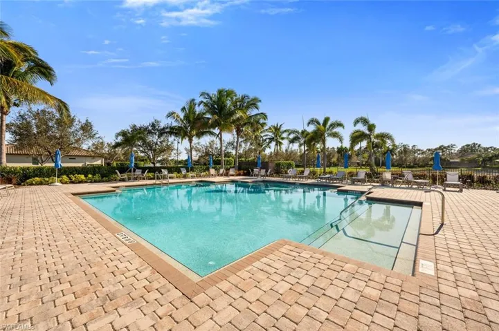 Community pool with a patio