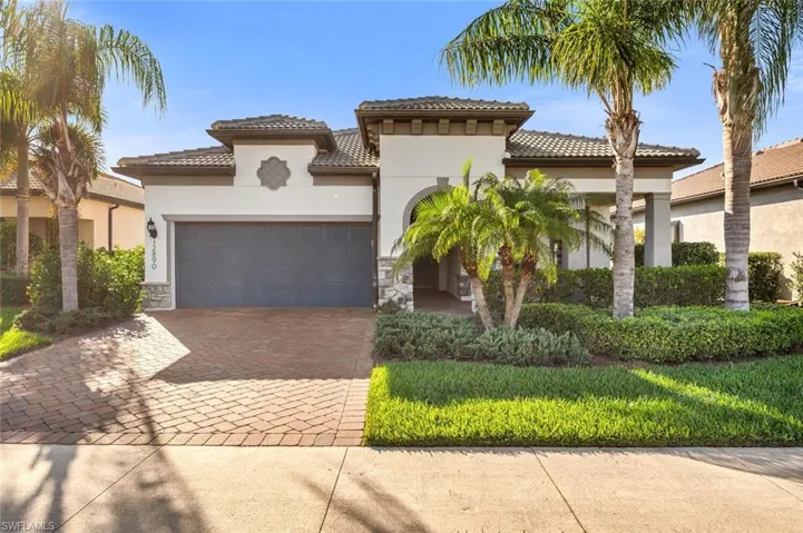 Mediterranean / spanish house featuring stone siding, stucco siding, decorative driveway, and a tiled roof