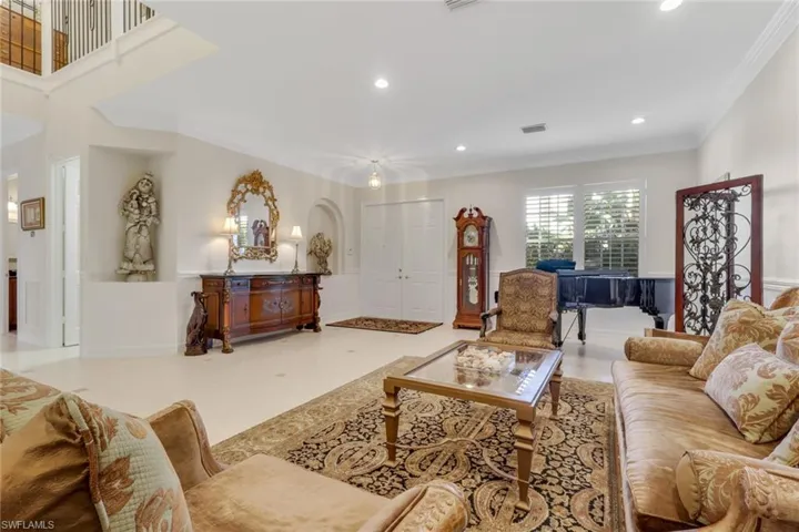 Living room with recessed lighting and crown molding