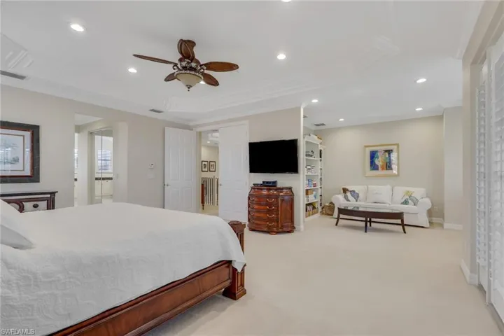 Bedroom with recessed lighting, light colored carpet, crown molding, and ceiling fan