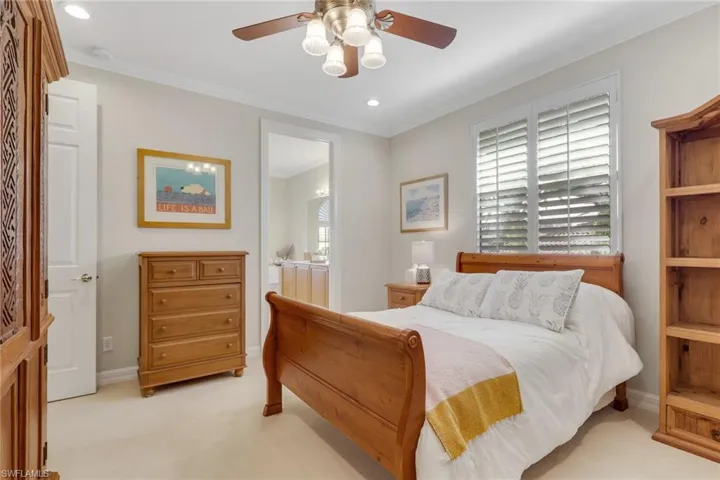 Bedroom featuring carpet flooring, crown molding, ceiling fan, ensuite bathroom, and recessed lighting