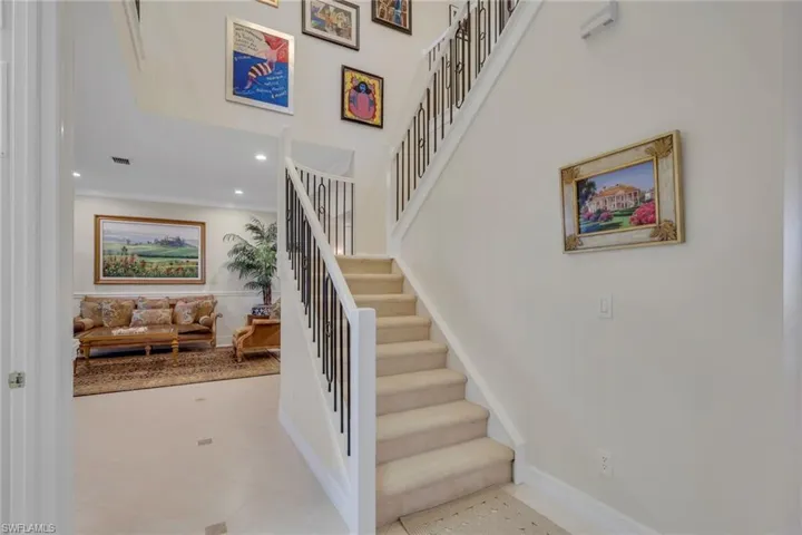 Stairway featuring tile patterned floors and recessed lighting