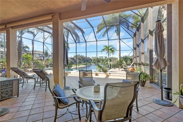 View of patio / terrace featuring a sunroom, an outdoor pool, a lanai, and a ceiling fan