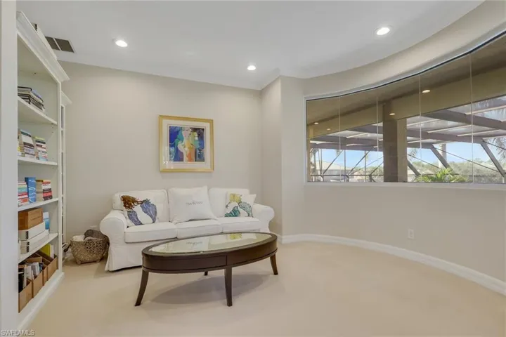 Living area featuring carpet floors, recessed lighting, and ornamental molding
