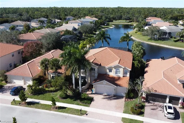 Aerial view of residential area featuring a large body of water