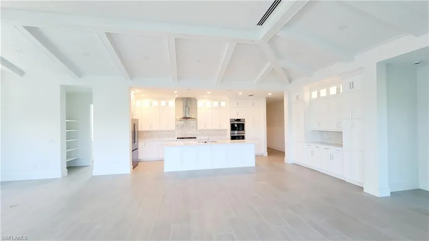 Kitchen featuring white 42" cabinetry and glass upper cabinets