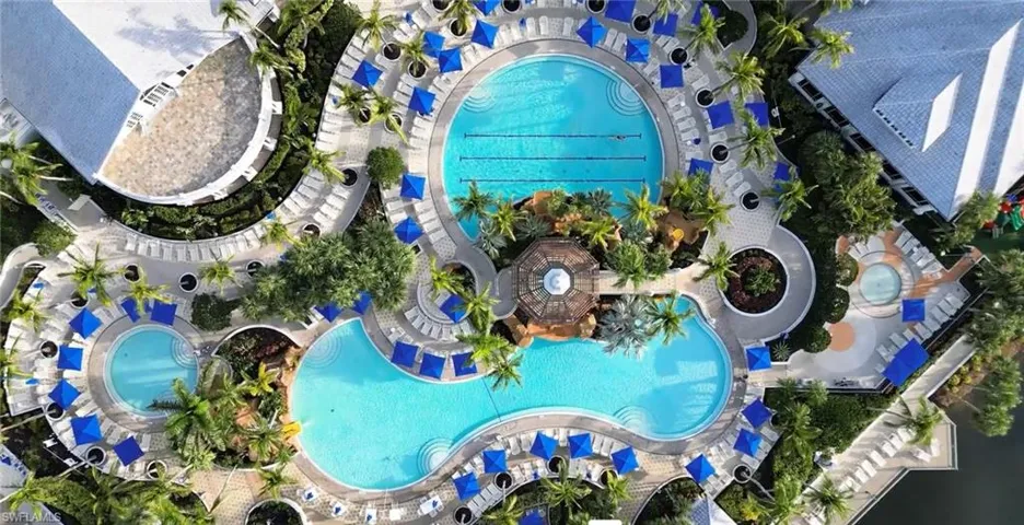 Aerial view of property and surrounding area featuring a pool area