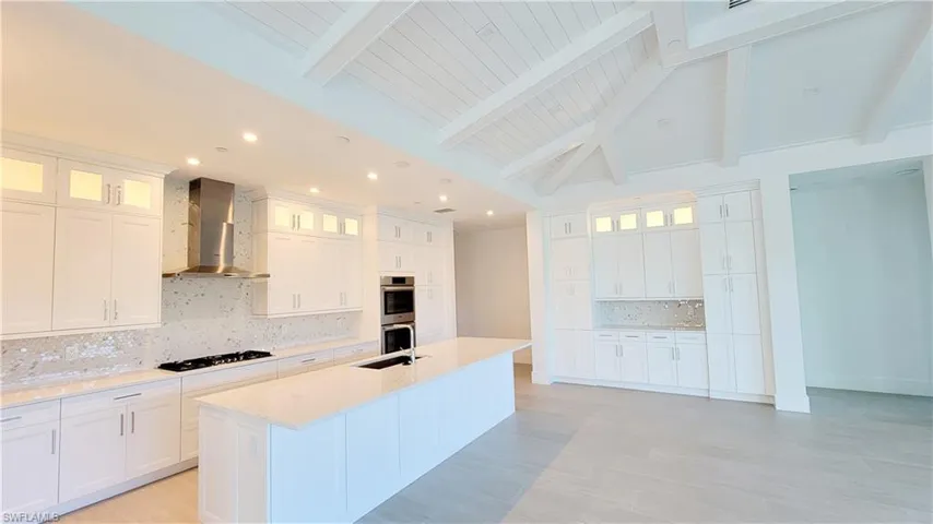 Kitchen featuring white 42" cabinetry and glass upper cabinets