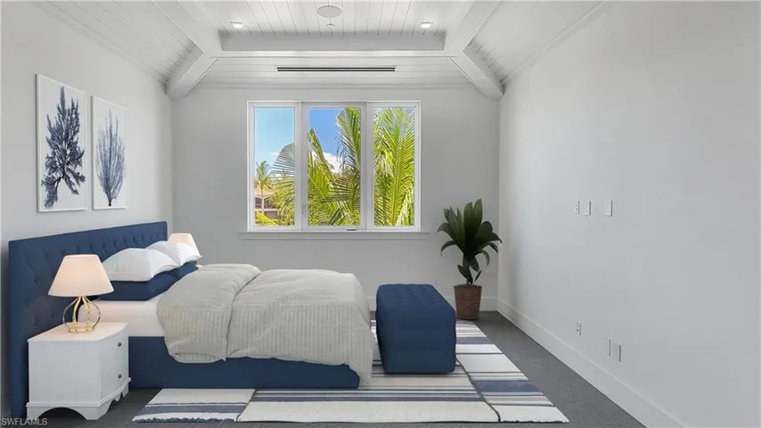 Guest bedroom featuring wood and vaulted ceiling with beams. Picture has digitally enhanced furniture.