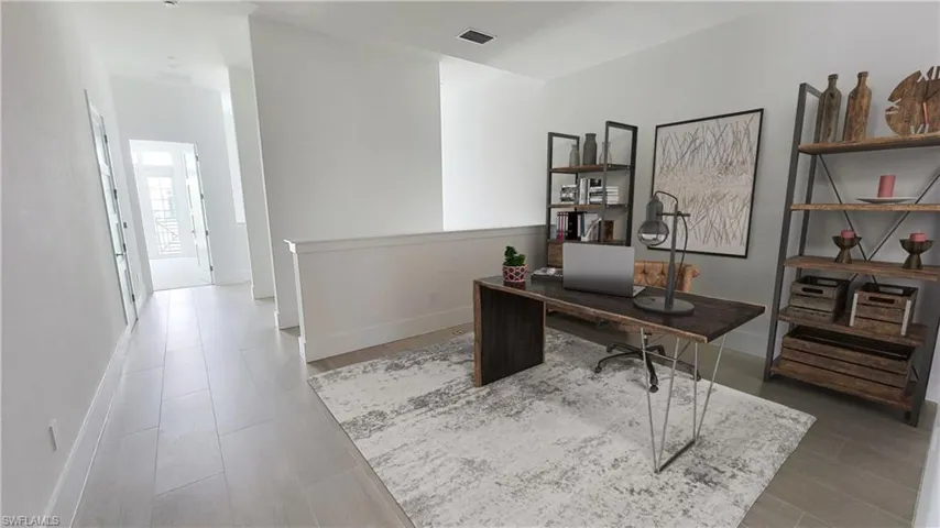 Office area featuring baseboards and wood finished floors