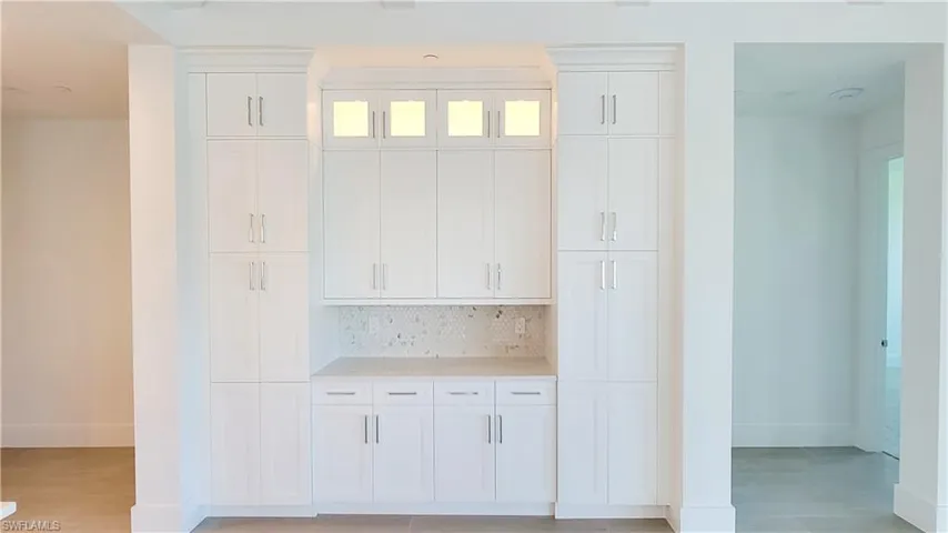 Dry Bar area with upgraded upper cabinet decorative glass door wall cabinets above