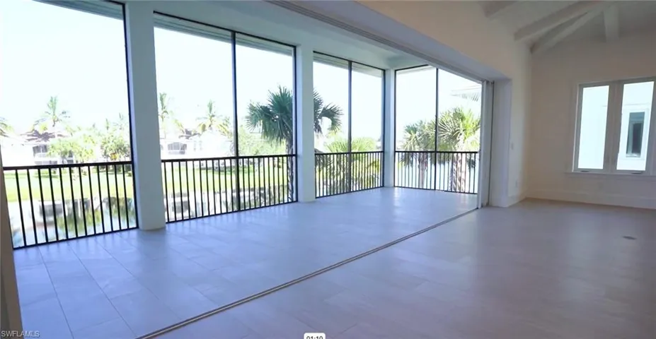 Spare room with beamed ceiling and baseboards