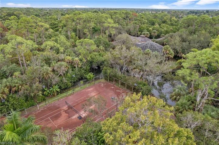 Tennis court with creek and main house